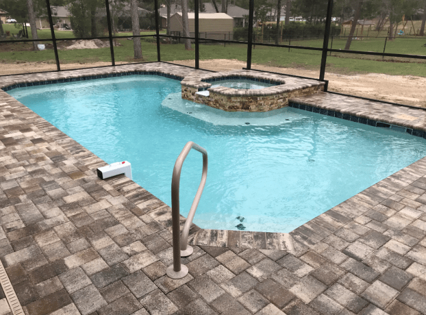 14 x 28 Heated Pool & side spillover spa, paver deck, & screen by Trinity Pools, Inc in Hernando County, FL.