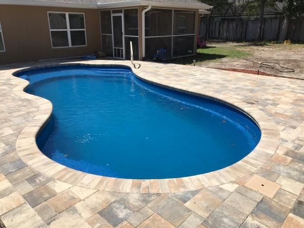 Inground pool installation by Trinity Pools, Inc. in Spring Hill, FL.