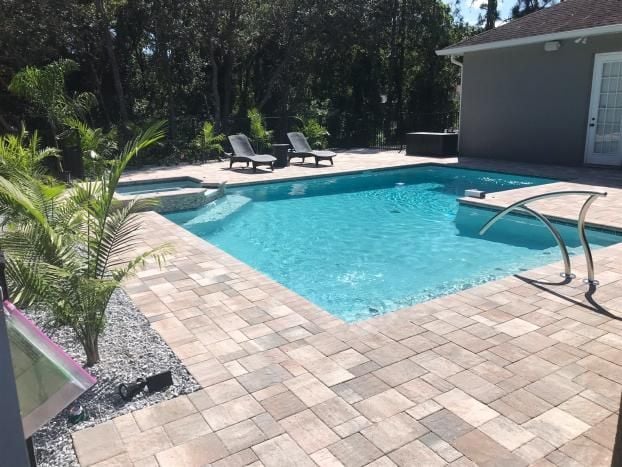 Inground pool installation by Trinity Pools, Inc. in Spring Hill, FL.